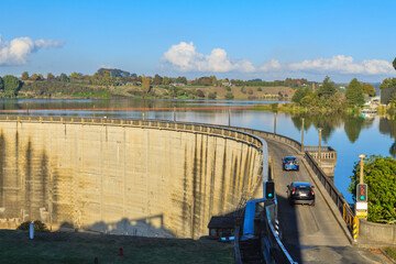 The Karapiro Dam on the Waikato River, New Zealand, built in 1948. Cars are driving over the public...