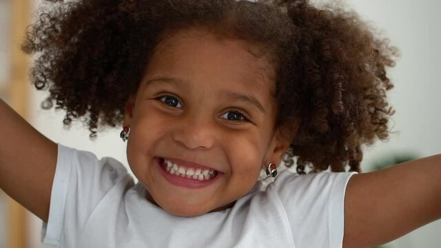 portrait headshot beautiful 10 years girl smiling looking happy, gesture hands Spbd. cute child has fun. african american kid express joy emotion indoors. concept positive, ethnicity