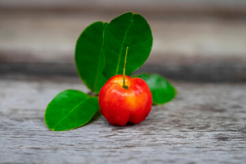 Acerola cherry fruit close up on wood background.