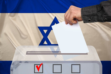 male voter drops a ballot in a transparent ballot box against the background of the national flag of Israel, concept of state elections, referendum