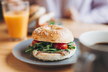 a large and mouthwatering bag-shaped sandwich with a delicate juicy stuffing on the coffee table. Breakfast for two in the instant cafe