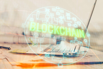 Double exposure of blockchain theme hologram and table with computer background. Concept of bitcoin...