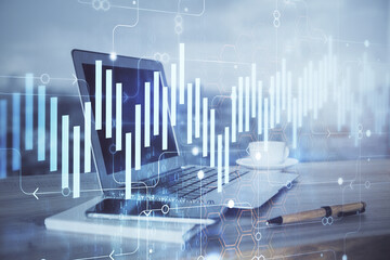 Stock market graph on background with desk and personal computer. Double exposure. Concept of financial analysis.