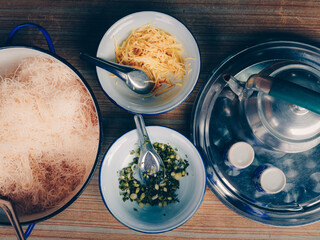 Pork congee with side dishes and deep-fried dough stick on the table