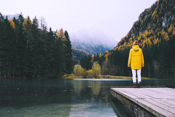 Fototapeta na wymiar Woman looking at mountain lake in Slovenia. Travel Europe.