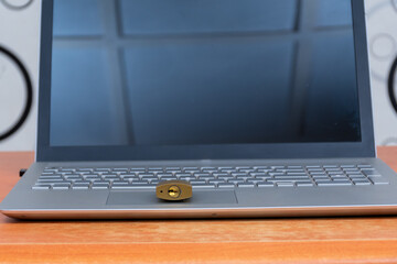 digital security concept. a padlock placed on a laptop computer keyboard to signify safety