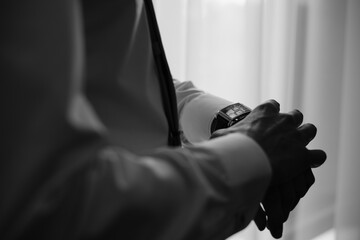 man watches time, Wrist Watch, the groom adjusts the watch