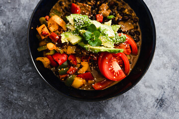 plant-based food, vegan poke bowl with mexican beans capsicums tomatoes and avocado