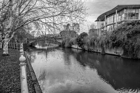 Black and white photo of the waterfront footpath along the River Wensum in the city of Norwich