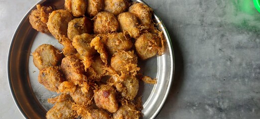 Potato fritters on an aluminum plate over gray