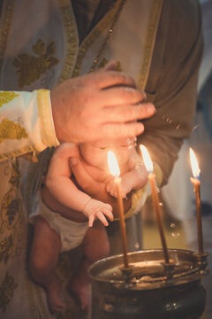 Orthodox Christian rite of baptism of a child. Baptism of the Child. Christianity. Bathing a child. Orthodox cross. Orthodox Church.