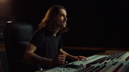Joyful man gesticulating in music studio. Happy guy listening to music indoor.