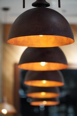 A group of hanging lights with shallow depth of field.
