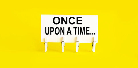 text once upon a time on white short note paper yellow background