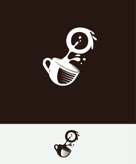 a cup of coffee with the letter O spilled