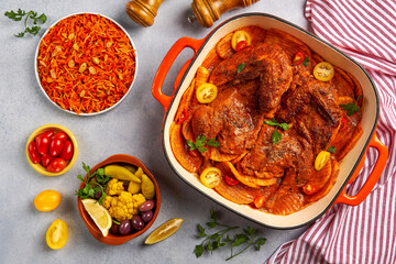Roasted chicken with potatoes in red sauce. Top view     