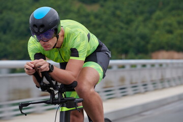 triathlon athlete riding a bike on morning training