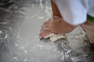 Fototapeta premium Kids playing with dough making homemade pastry products