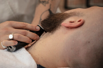 barber cares for his client's beard