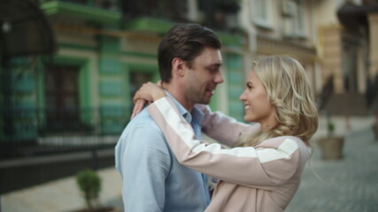 Fototapeta premium Business couple looking at each other outside. Love couple hugging at date