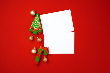 Blank sheet of paper with gingerbread cookies on red background
