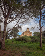 mediterranean little chapel over a hill in the countryside. Menorca, Spain.