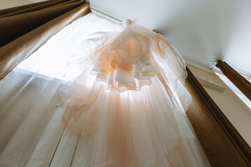 Hanging white wedding dress. Bottom view