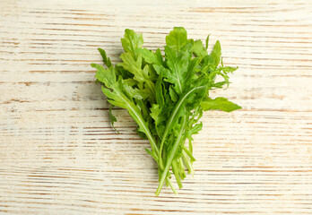 Fresh arugula on white wooden table, flat lay
