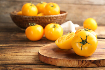 Delicious ripe yellow tomatoes on wooden table