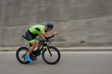 Fototapeta premium triathlon athlete riding a bike on morning training