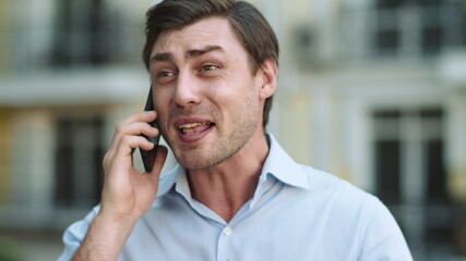 Portrait serious man having phone talk. Angry businessman talking on smartphone