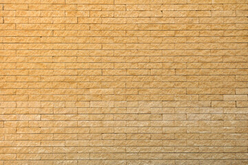 Panoramic image yellow background brick wall texture.