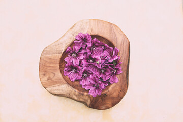 Fototapeta na wymiar Mallow Blossoms in a Bowl, Spa treatment, Wellness