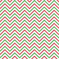 Background zigzag pattern in traditional Christmas colors. Vector seamless texture in red and green. New Year theme.