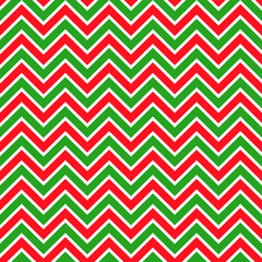 Background zigzag pattern in traditional Christmas colors. Vector seamless texture in red and green. New Year theme.