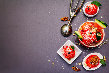 Watermelon ice cream or sorbet with coconut flakes, walnuts and fresh basil leaves