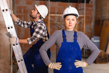 Female foreman checking the work of the builders in house. High quality photo