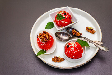 Watermelon ice cream or sorbet with coconut flakes, walnuts and fresh basil leaves