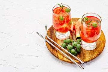 Fresh non-alcoholic fruit cocktail with juicy watermelon, green grape, rosemary and tonic water