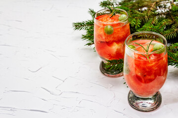 Festive low alcoholic fruit cocktail with watermelon, green grape and rosemary
