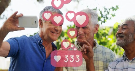 Heart icons with increasing numbers against three senior man taking a selfie - Powered by Adobe
