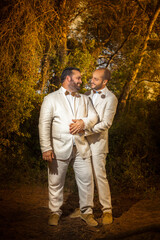 gay couple in the forest after the wedding