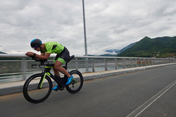 triathlon athlete riding a bike on morning training