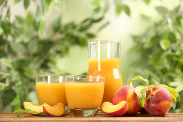 Natural peach juice and fresh fruits on wooden table