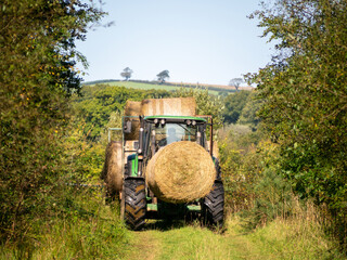 Autumn in nature, with tractor. Devon, UK. Hay bales.