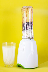 smoothie with cottage cheese and fresh berries on a solid yellow background