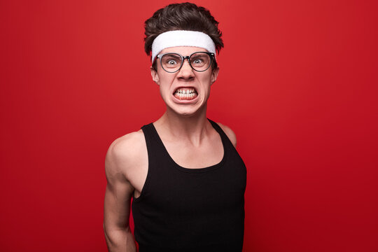 Angry nerd in sportswear looking at camera