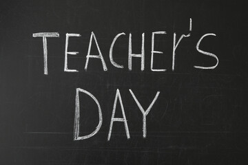 Words TEACHER'S DAY written with chalk on blackboard