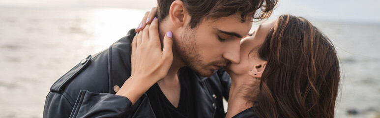 Fototapeta premium Horizontal crop of woman touching neck of boyfriend beside sea