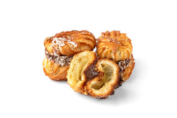 Profiteroles with condensed milk isolated on white background.